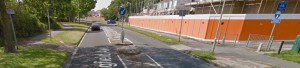 Sharp turn to join the cycle path, and judging by the grass damage it looks like a common issue. [Source; Google Streetview]